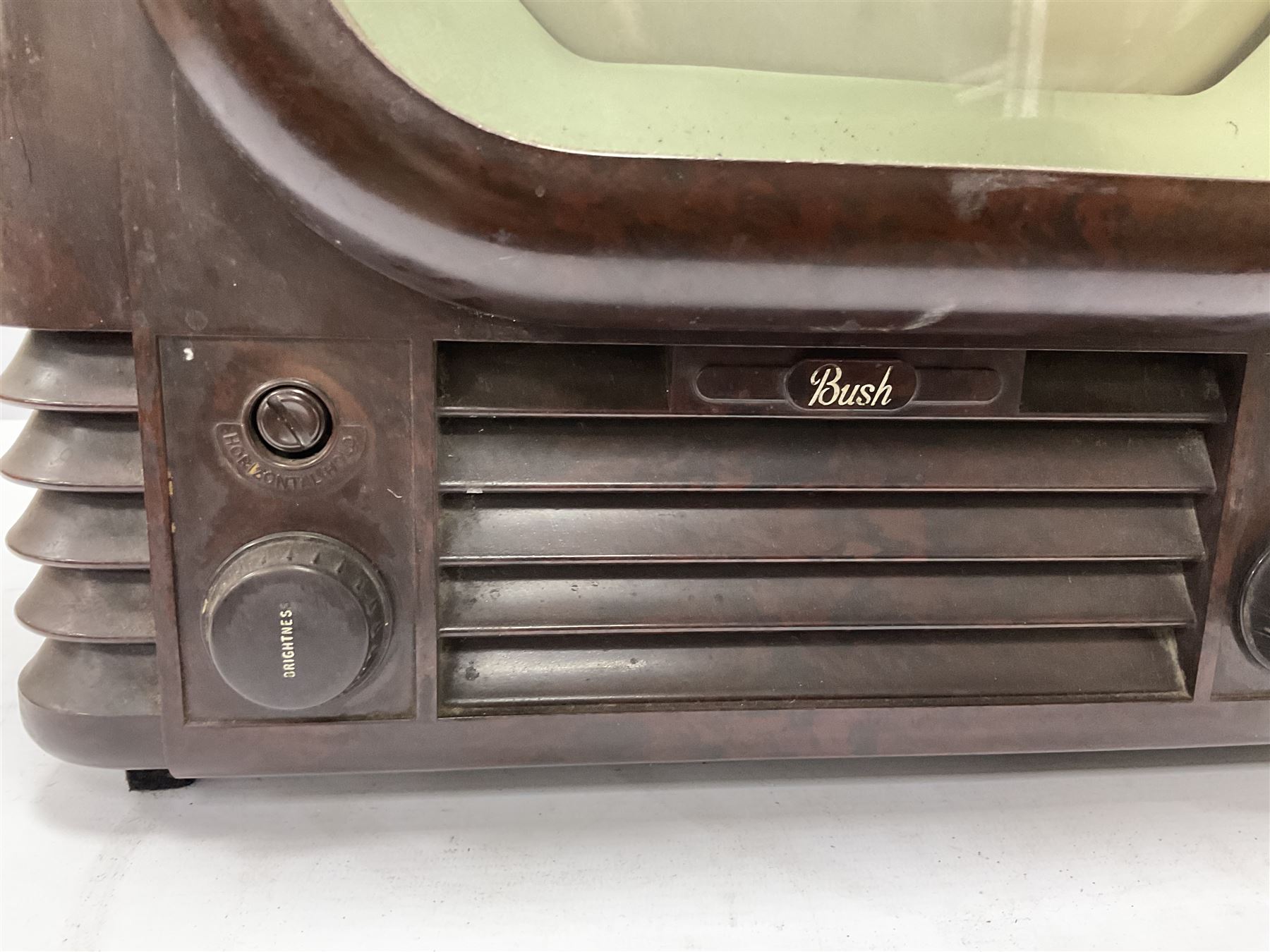 1950s Bush Type TV22 Bakelite Television receiver, the TV cased in marbled brown Bakelite of stepped form, the 9 inch screen with white mask, with original leather cover casing to reverse, H39cm D34cm W38cm