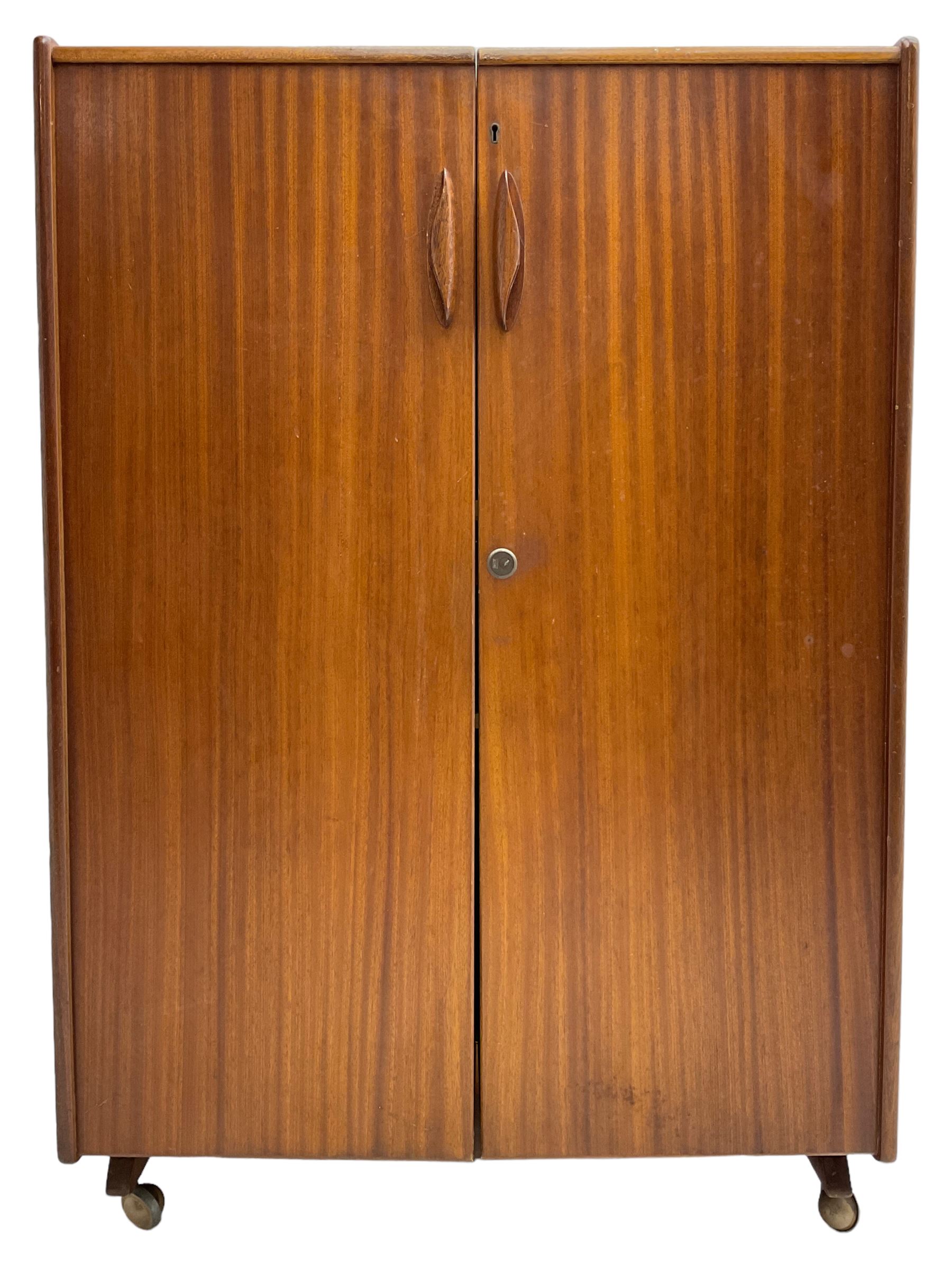Mummenthaler & Meier - mid-20th century circa. 1960s teak 'Magic Box' folding desk cabinet, the cabinet opens to reveal shelves, writing desk, document holders and lamp, on castors