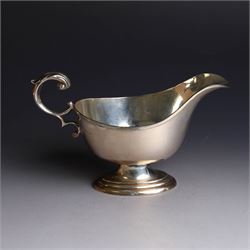1930s silver sauce boat, of typical form with acanthus capped flying C scroll handle and upon stepped oval foot, hallmarked William Hutton & Sons Ltd, Sheffield 1938, height including handle H10cm