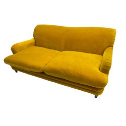 Loaf - large two seat 'Jonesy' sofa, upholstered in mustard velvet fabric with sprung back and loose seat cushions, raised on pale oak turned supports