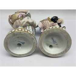 Pair of late 19th/early 20th Century Meissen figures, modelled as flower sellers, after the original by Michel Victor Acier, she holding basket of flowers, he holding flowers in his hat, each with underglaze cross swords mark beneath, tallest H16.5cm