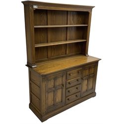 Ercol - mid-20th century dark elm 'Old Colonial' dresser, two tier plate rack with fluted uprights, base fitted with four drawers flanked by two panelled cupboards