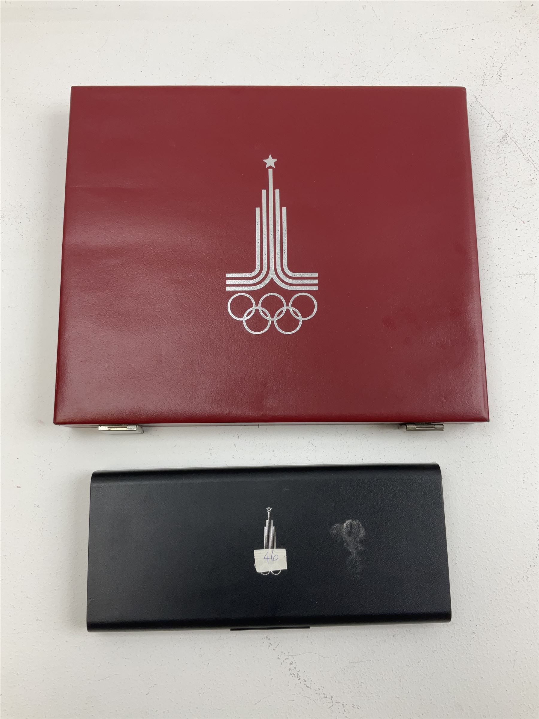 Russian 1980 Moscow Olympic Games silver twenty eight coin set, housed in dated red case and four other coins relating to the Olympics, housed in dated black case
