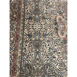 Large Persian design carpet, pale brown ground with scrolling floral decorated medallion, the field with all-over foliate designed with animal and bird motifs, multi-band border decorated with trailing foliage and stylised plant motifs