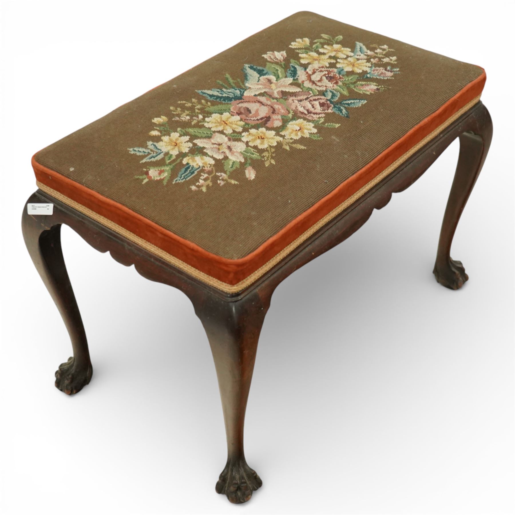Georgian style mahogany dressing stool, rectangular upholstered top embroidered with a floral needlework panel within a velvet border and braid trim, moulded frieze, raised on cabriole legs terminating in large carved claw and ball feet