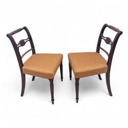 Pair of Regency mahogany side chairs, reeded bar backs centred by oval paterae, overstuffed seats upholstered in gold geometric patterned fabric, on turned tapering front supports 