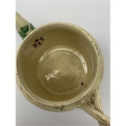 18th century creamware teapot, probably Leeds, with reeded entwined handle and floral finial to the cover, the body with hand painted polychrome decoration of figure to one side, and floral spray to the other, collectors paper label beneath inscribed Leeds Pottery, H11.5cm