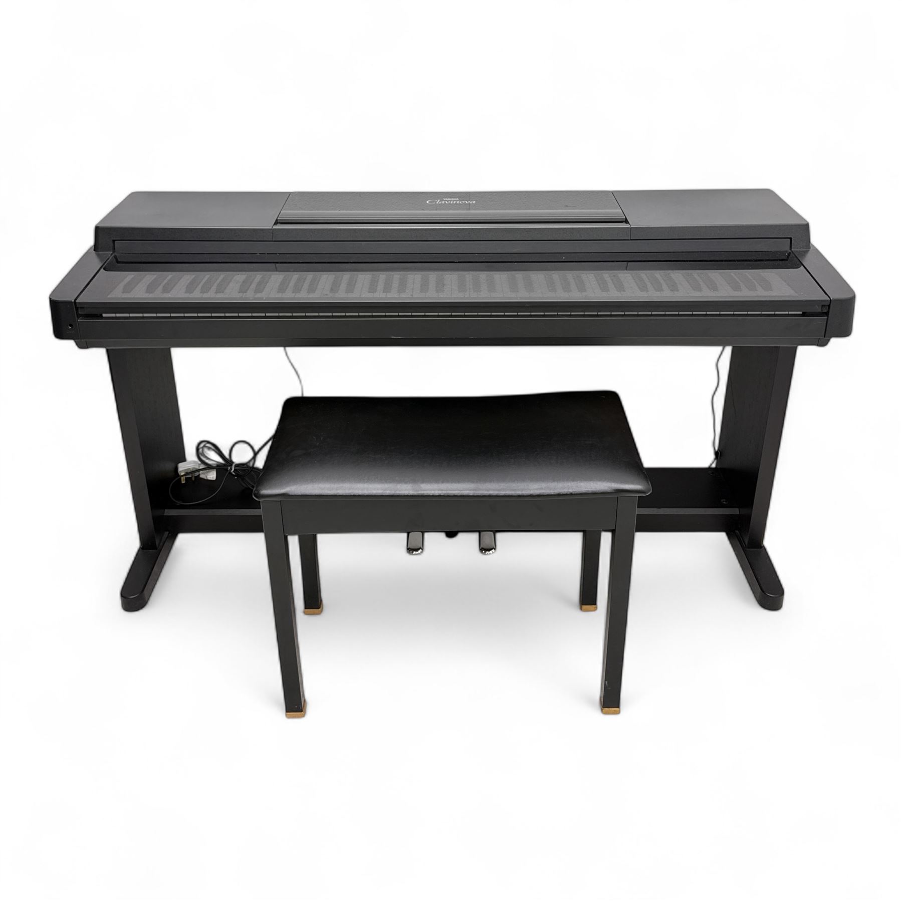 Yamaha Clavinova CLP-550 digital piano, full-size weighted keyboard with integrated pedals and speakers, in dark wood effect casing, accompanied by matching padded bench, Sennheiser headphones, original manuals, and factory-issued cassette tape titled 'Pure & Simple – CLP Digital Pianos'