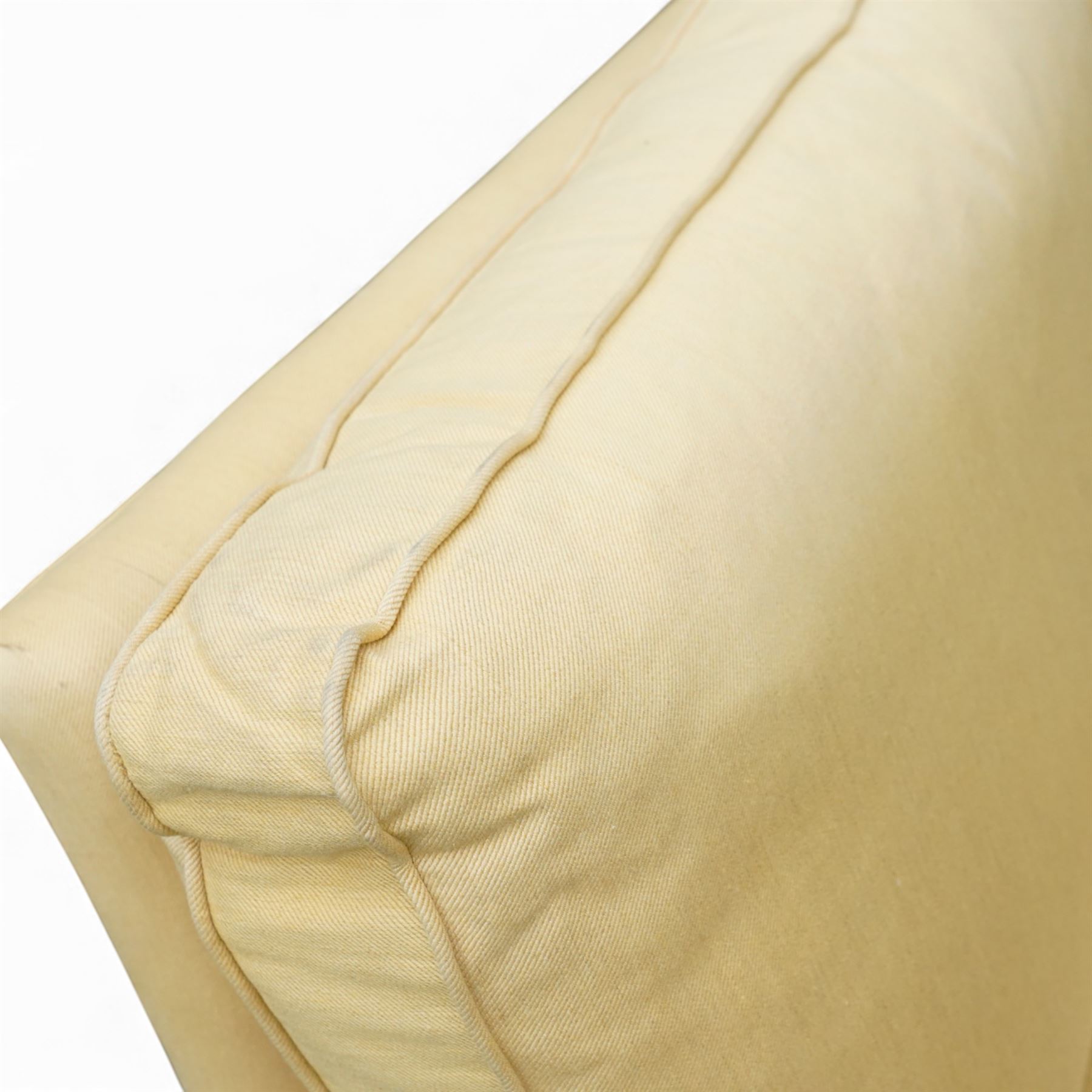 Pair of mid-20th century traditional two seat sofas, loose cushioned seat and back upholstered in pale gold fabric, on turned supports