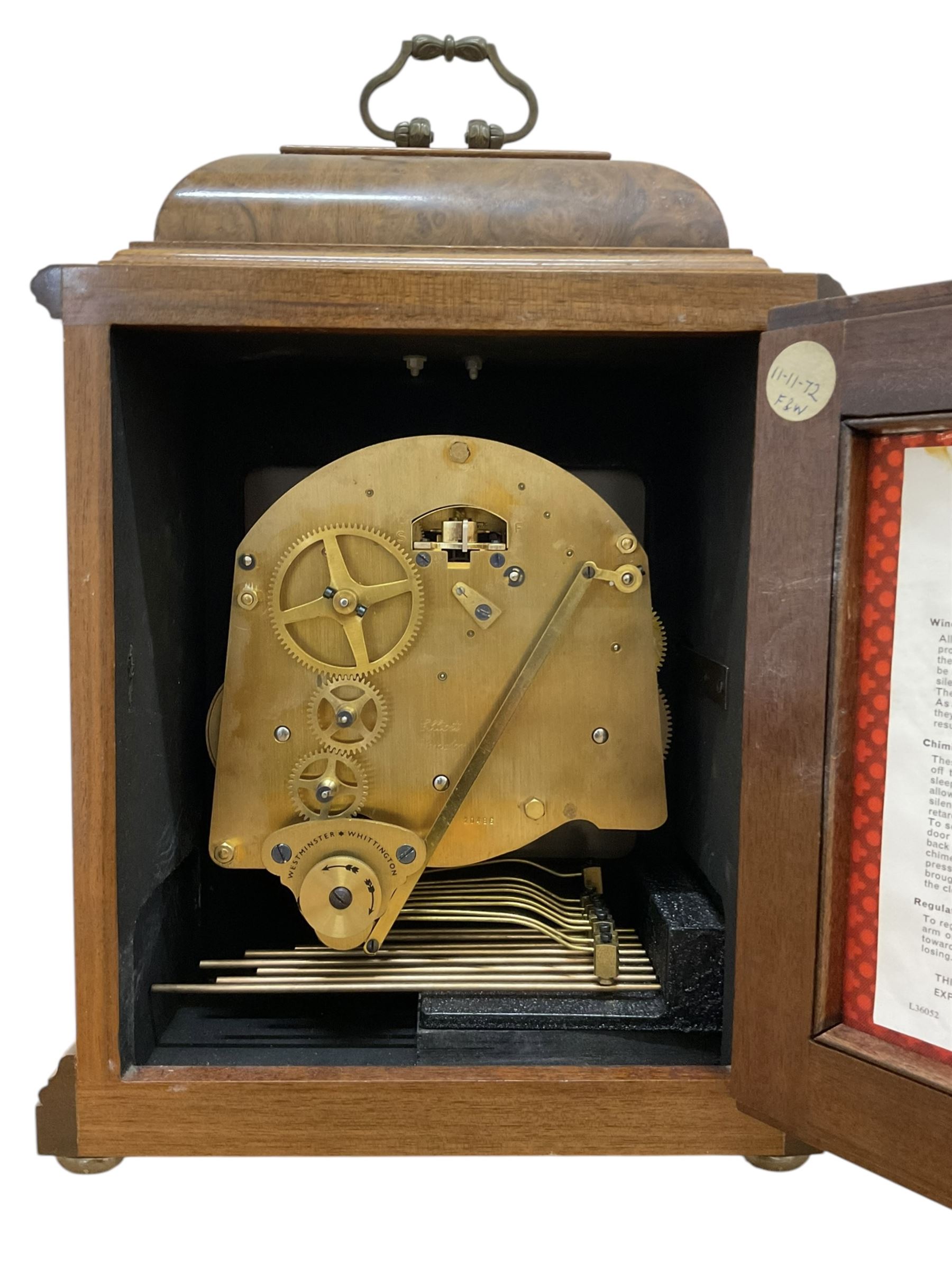 Elliot- late 20th century 8-day walnut bracket clock in an 18th century styled case, with a brass dial, brass spandrels and a slivered chapter ring, three train Westminster chiming movement with a lever balance escapement, chiming the quarters on eight gong rods.