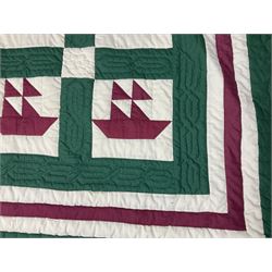 20th century quilt, with repetitive ship design to the centre within a cream red and green boarder, 227cm x 222cm