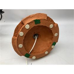 Terracotta studio pottery lamp base with carved detail and geometric knop and base, H45cm, together with a black chandelier with drops, Mid century teak light fitting with three drop down clear glass pendants and copper mounts, H54cm, and Rhinestone and black eight branched chandelier