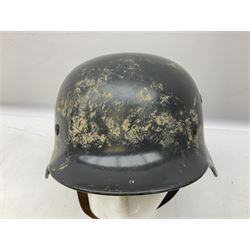 WW2 German steel helmet painted in undecaled Luftwaffe bluey grey with leather liner and chin strap stamped '58', the skirt impressed '1250'