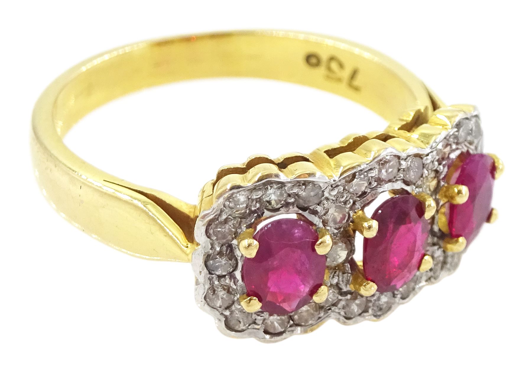 18ct gold three stone oval cut ruby and diamond cluster ring, stamped 750