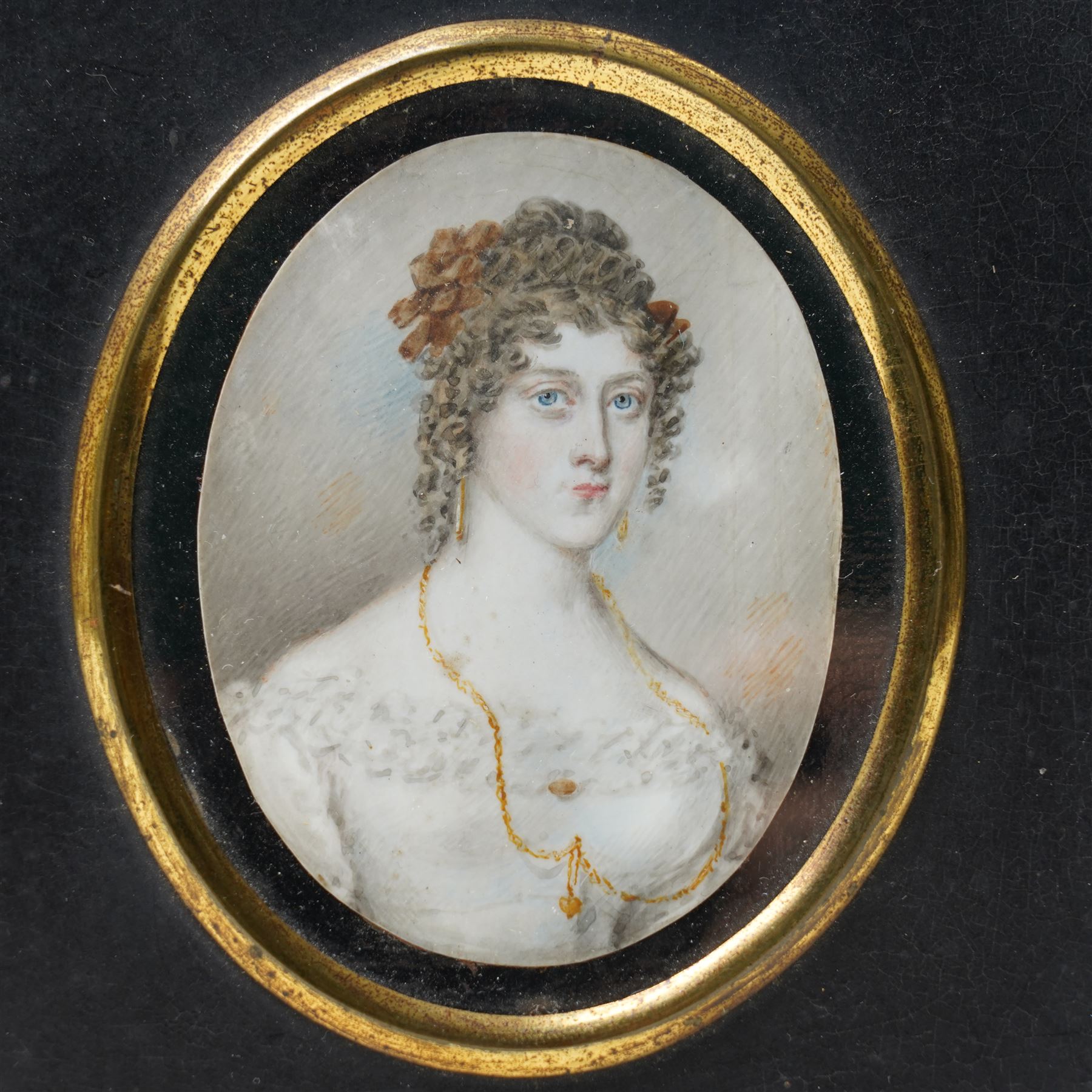 19th century miniature half length portrait on ivory of a lady wearing a gold locket, ebonised frame 13.5cm x 11.5cm