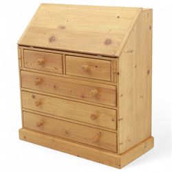 Contemporary waxed pine bureau, fall front enclosing fitted interior with pigeonholes and drawers, over two short and three long drawers with turned wooden knobs, on plinth base