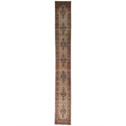 Large Persian Herati ivory ground 18' runner, seven floral medallions and a field decorated with repeating Herati motifs, three-band border decorated with geometric and flower head motifs