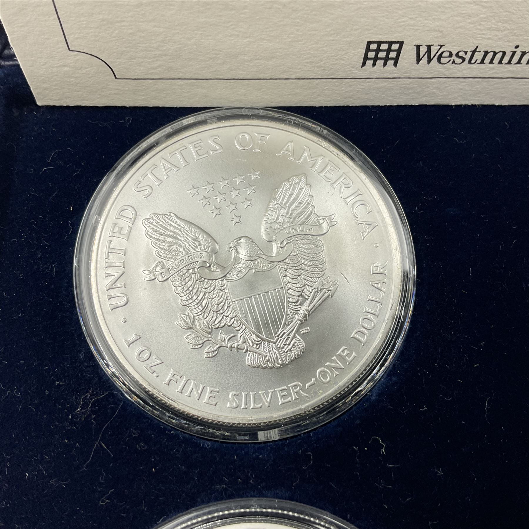 Four one ounce fine silver coins, forming 'The 2003 Famous World Silver Coin Collection', comprising United States eagle, Australian kangaroo, Chinese panda and Canadian maple leaf, cased with Westminster certificate 