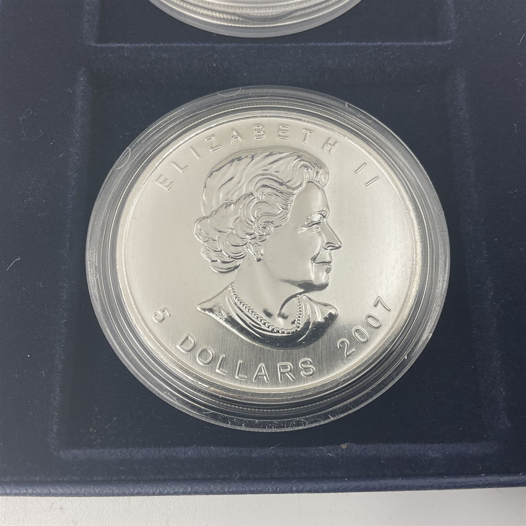 Four one ounce fine silver coins, forming 'The 2007 Famous World Silver Coin Collection', comprising United States eagle, Australian kookaburra, Chinese panda and Canadian maple leaf, cased with Westminster certificate 
