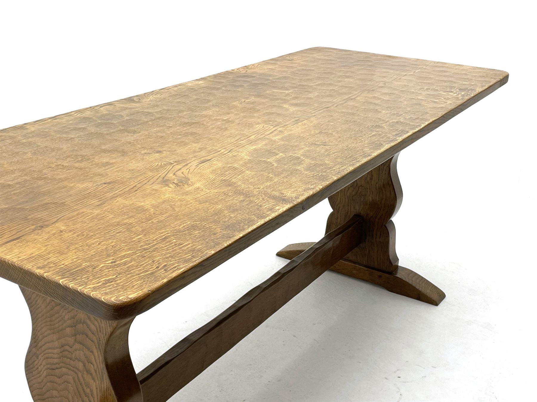 ‘Gnomeman’ oak dining table, rectangular adzed top, shaped end supports on sledge feet joined by pegged stretcher, carved with gnome signature, by Thomas Whittaker of Littlebeck