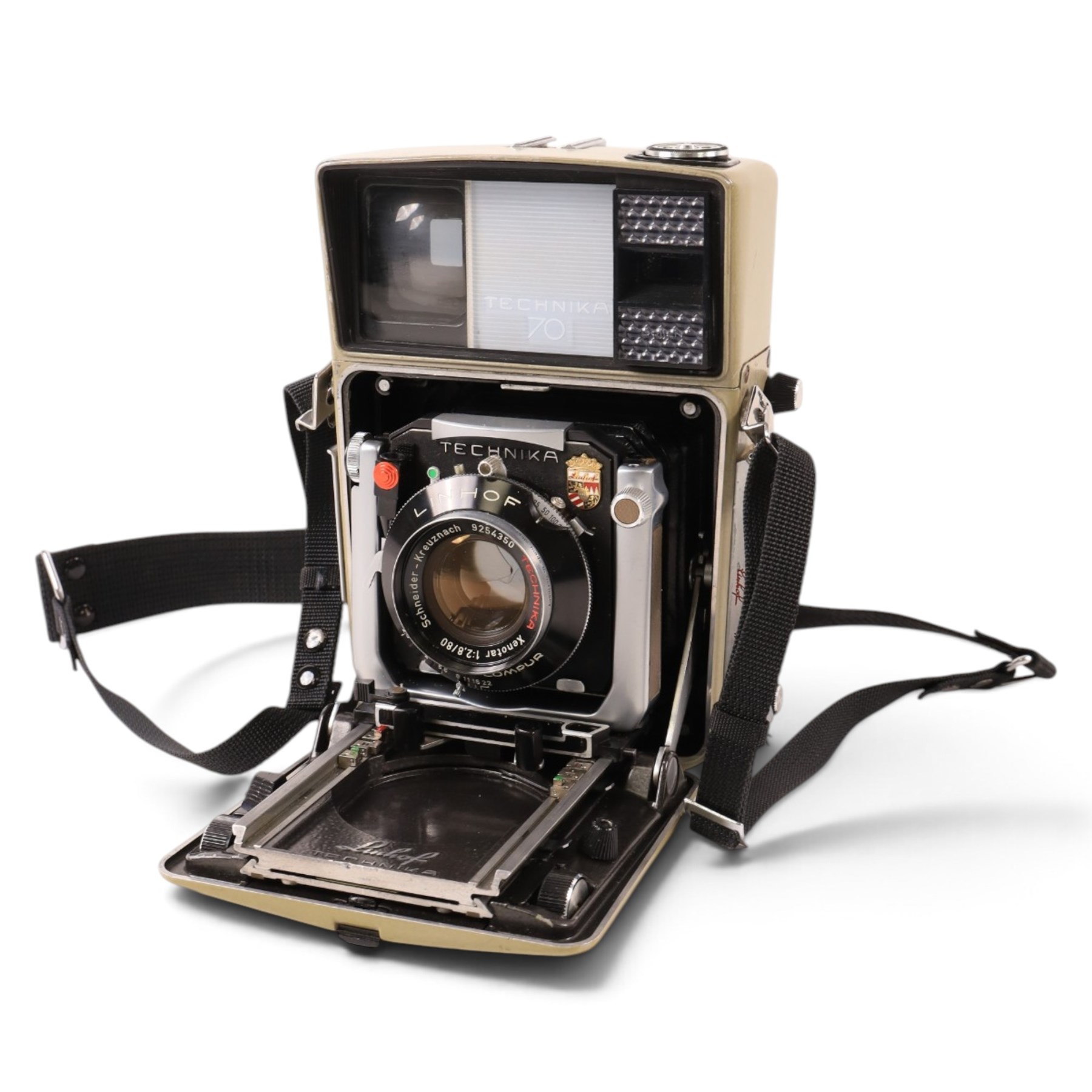 Linhof Tecnika 70 medium format press camera serial no. 1711919, with a Xenotar 1:2.8/80 lens serial no. 9254350 and a Symmar 1:5.6/180 lens serial no. 8357904, both coupled to the camera, and additional accessories including Symmar-S 5.6/100 lens, and a Carl Zeiss Jena Apo-Lanthar 40mm1:4.5 macrolens, numbered set of seven Linhof dark slides, super rollex roll film holder and anatomical grip, all contained within modern case