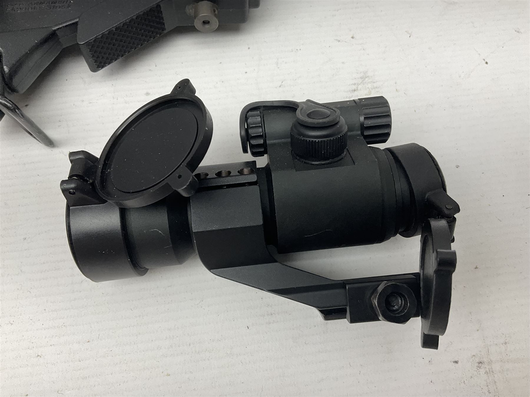 Assorted shooting accessories including two telescopic sights, red dot sight,  two bi-pods, spirit level mount, two gun butts and two forward handles