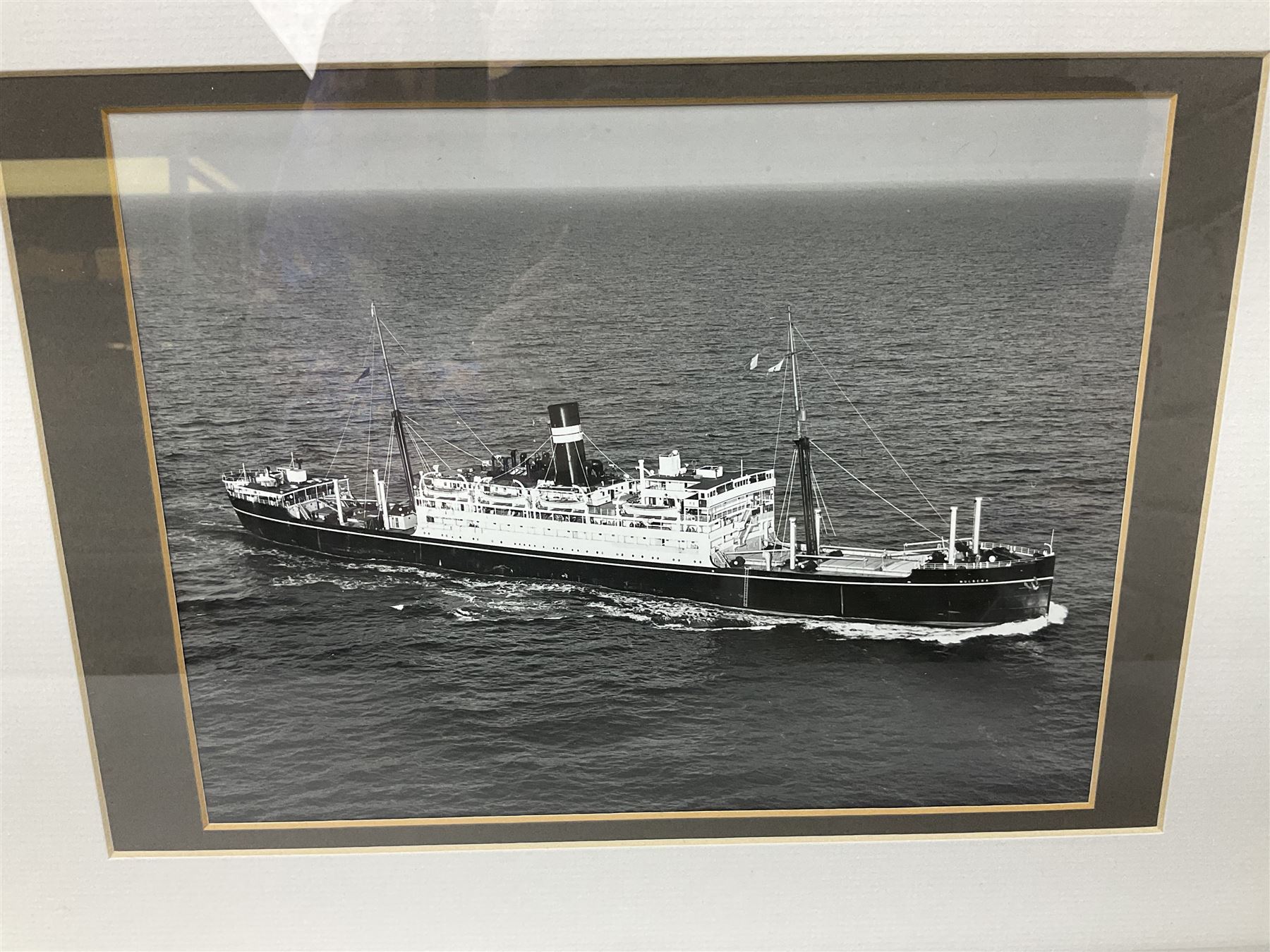 Set of twelve monochrome photographs of mid-20th century merchant vessels comprising general cargo ships, cargo liners, RMMV passenger cargo liners and hospital ship including Rowallan Castle, Drakensberg Castle, Stirling Castle, Capetown Castle, Pachumba, Tilapa etc; average size 18 x 24cm; uniformly mounted in black frames (12)