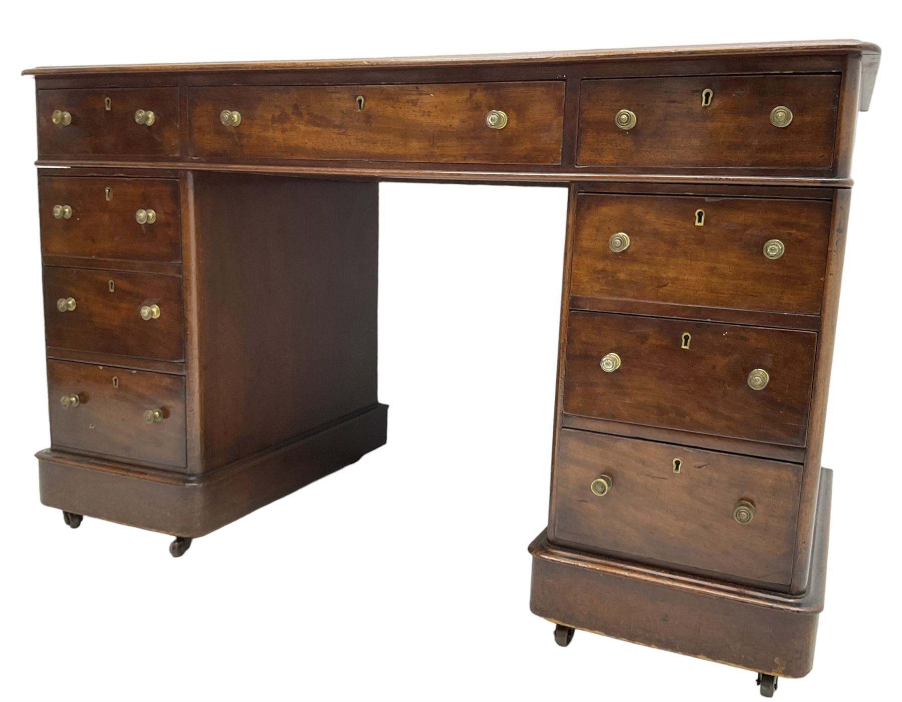 Victorian mahogany twin pedestal desk, rectangular top with inset ebonised leather writing surface, fitted with nine graduating drawers with brass pull handles, on plinth bases