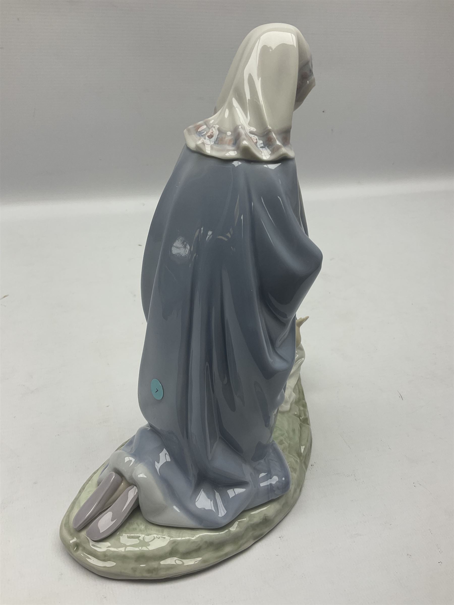 Lladro figure, Holy Night, modelled as Mary kneeling over baby Jesus, sculpted by Vincente Martinez, with original box, no 5796, year issued 1991, year retired 1994, H22cm