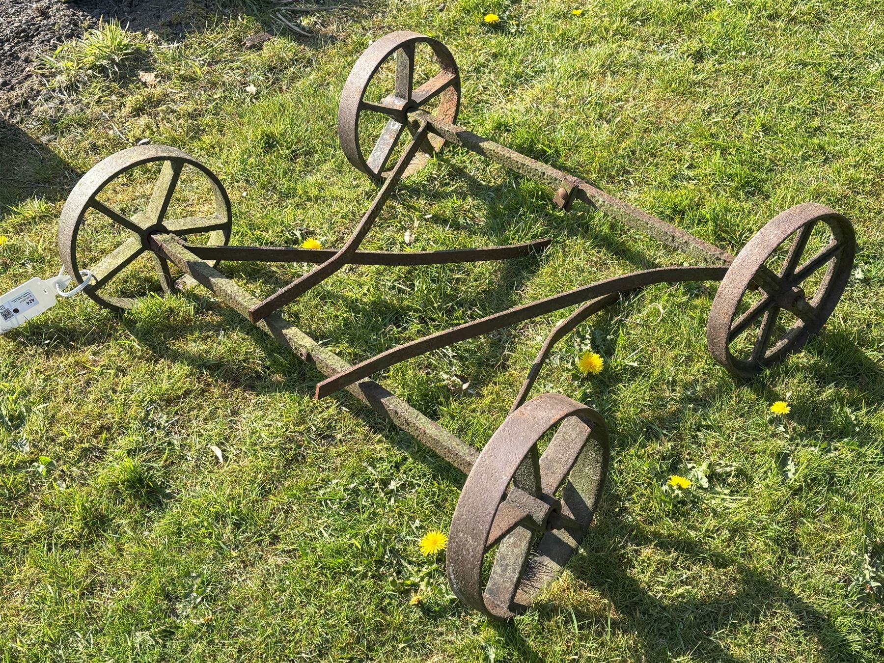 Two pairs of iron cart wheels on axles L93cm