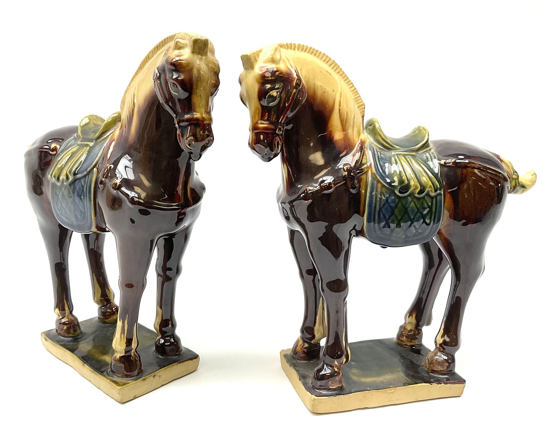 A pair of glazed pottery Tang style horses, each with impressed marks beneath, each approximately H25.5cm. 