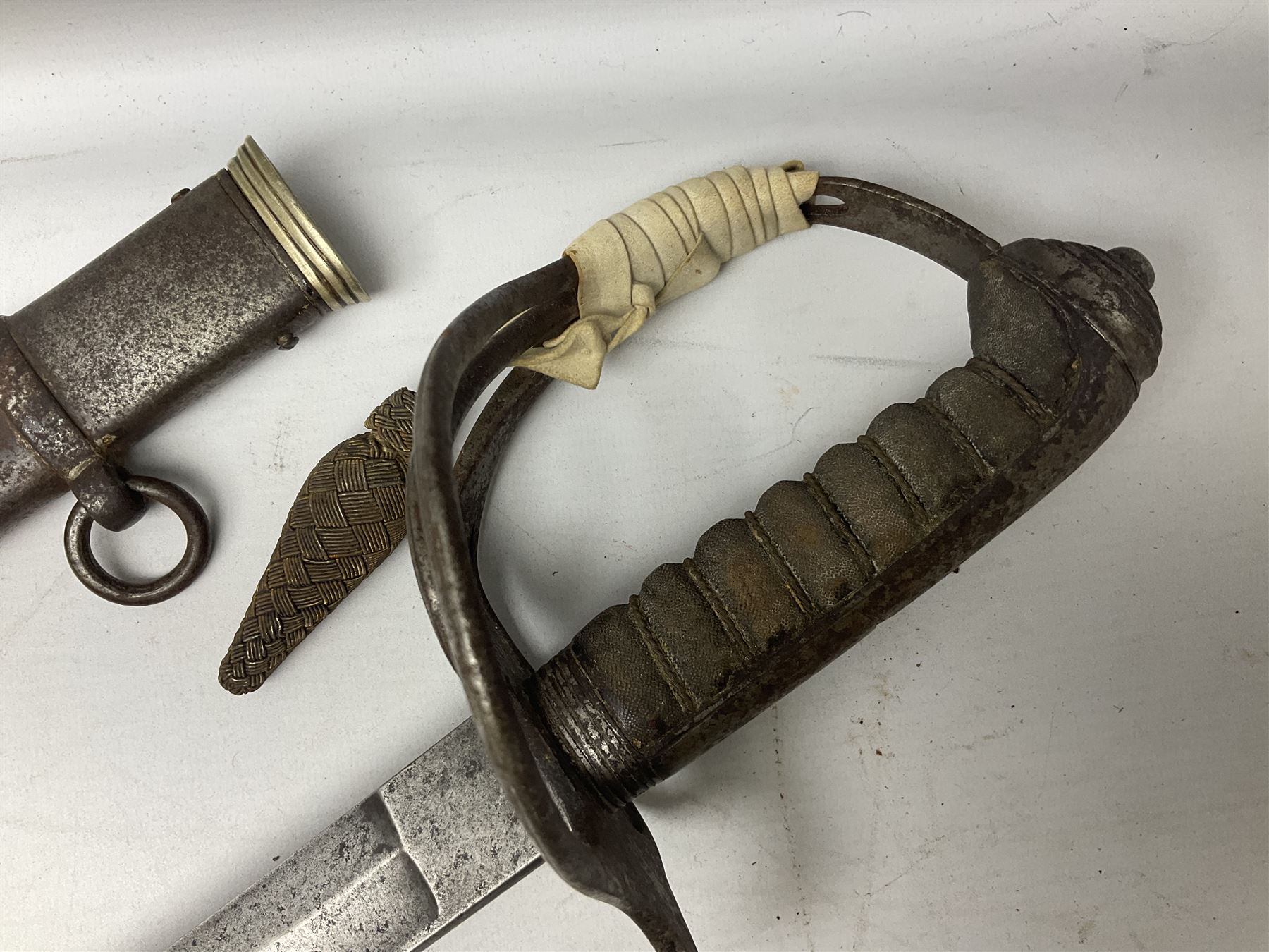 British 1821 Pattern Light Cavalry Officer's sword, with plain 87.5cm slightly curving fullered steel blade and plain steel three-bar hilt with wire-bound fish skin grip and plaited knot on later cord; in steel scabbard with two hanging rings L103cm overall