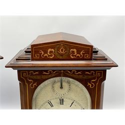 Close matching pair of German Westminster chiming mantle clocks c1910, inlaid mahogany case in the Edwardian Sheraton style with an engraved silvered sheet dial, Roman numerals, minute track and steel spade hands with subsidiary chime/silent dial above, eight-day spring driven three train movement sounding the quarters and hours on five gong rods. With pendulum.


