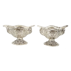 Four Victorian silver pedestal bon bon dishes, embossed foliate and pierced decoration, with glass liners by Charles Stuart Harris, London 1892, height 13cm