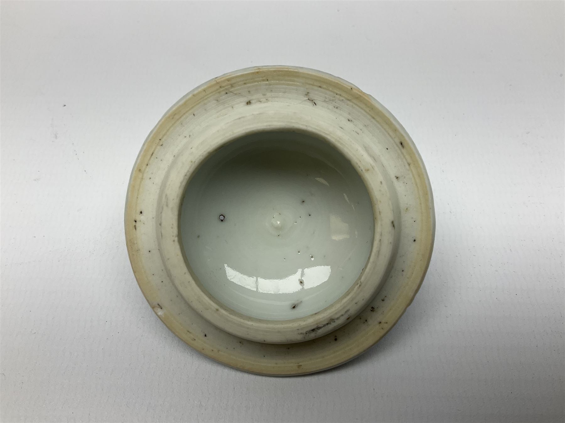 Two late 18th/early 19th century Chinese export teapots, the largest example of globular form with curved handle and straight spout, decorated in the Mandarin style with figural scenes surrounded by red scale reserves, H13.5cm, the second smaller example decorated in underglaze blue with two musicians in a landscape set with willow tree and fence, H10.5cm

