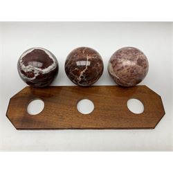 Set of three marble spheres on a elongated octagonal wooden base, H12cm
