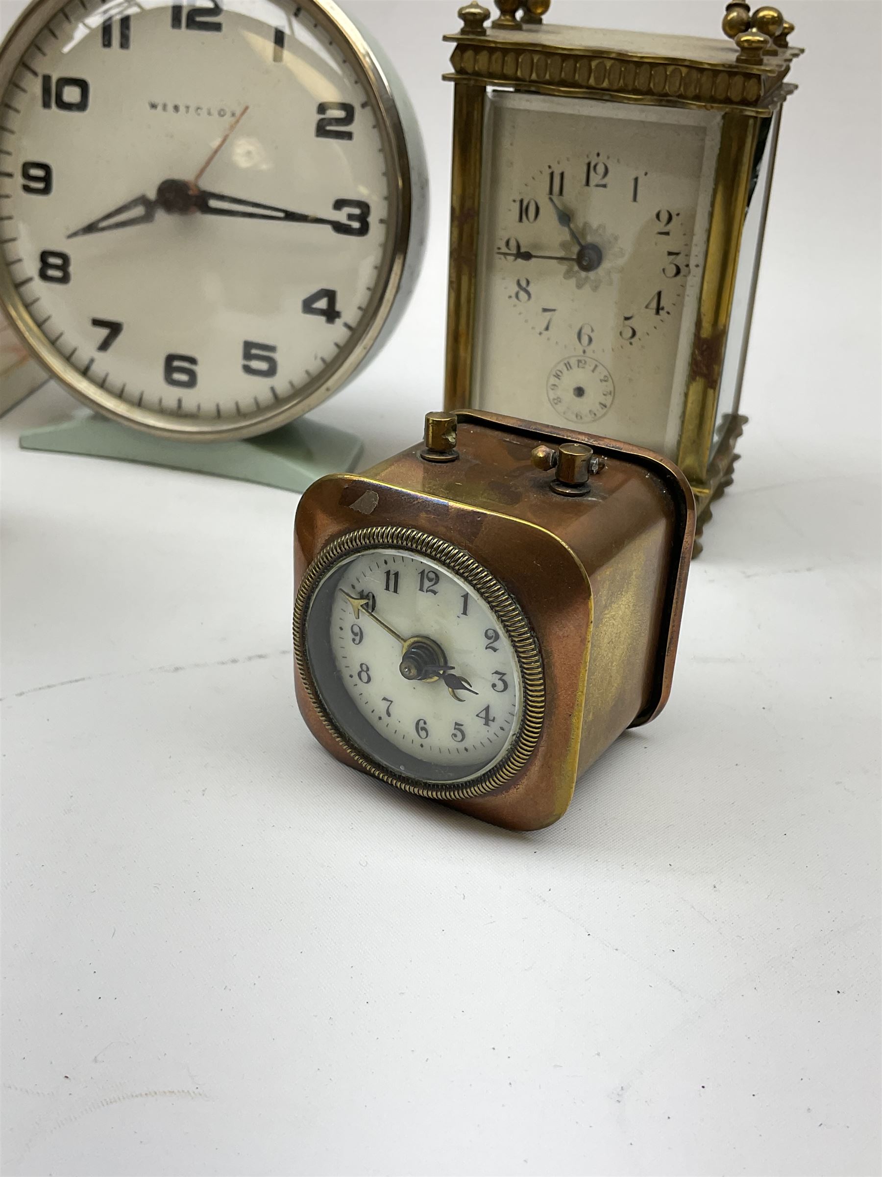 Miniature 'Zenith' travel alarm clock, in engine turned brass case with
