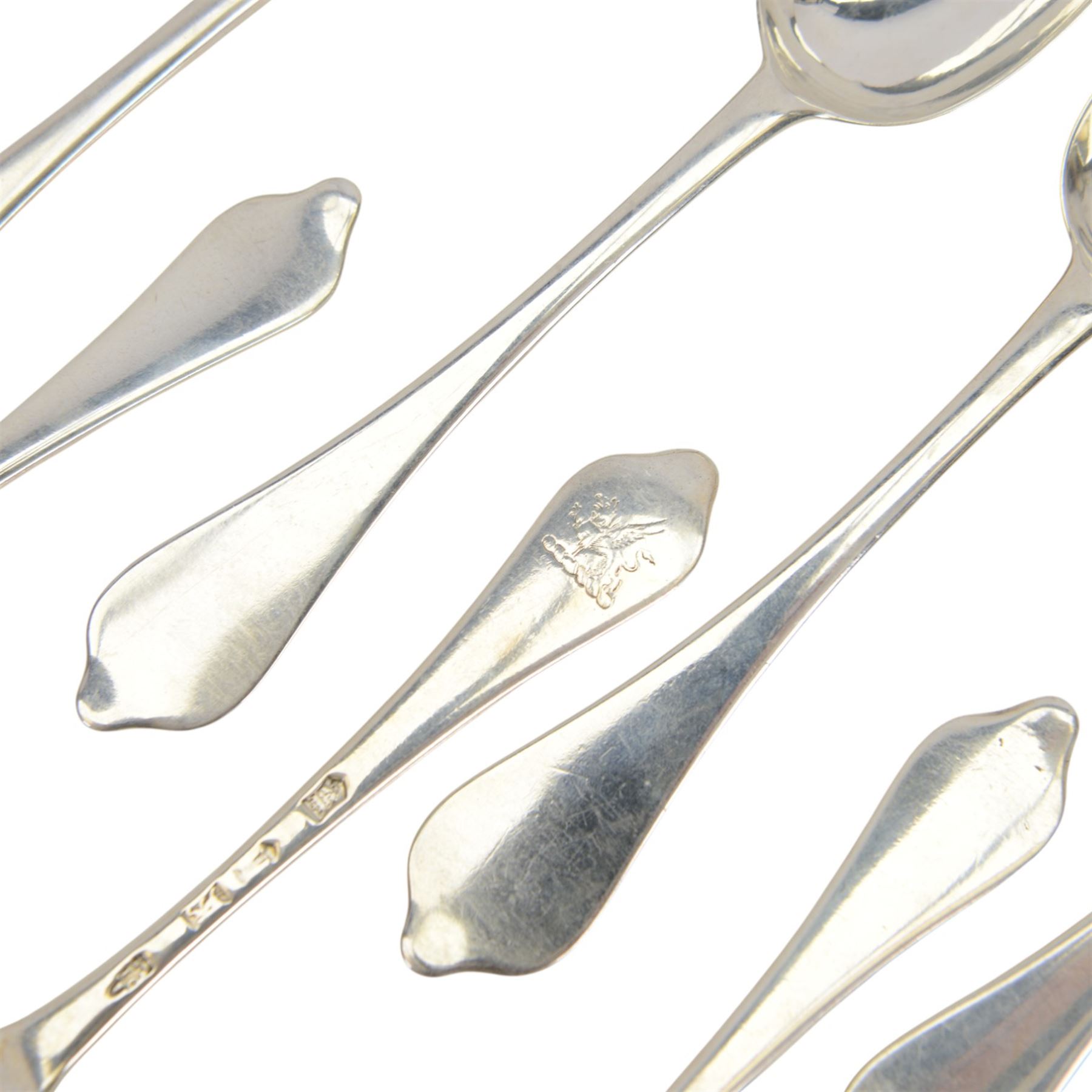 Twelve silver dog nose spoons, comprising a set of eight George II examples with drop heels  and engraved crest to terminals, hallmarked Isaac Callard, London 1732, three with rat tail bowls, circa 1722, hallmarked Samuel Hitchcock, London, date latter worn and indistinct, and a Britannia standard with rat tail bowl, circa 1718, each approximately L20cm