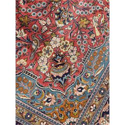 Persian Kashan peach ground rug, central rosette medallion surrounded by trailing branches and flower heads with bird motifs, light blue spandrels with further floral decoration, the main border with repeating palmettes and birds, within guard stripes