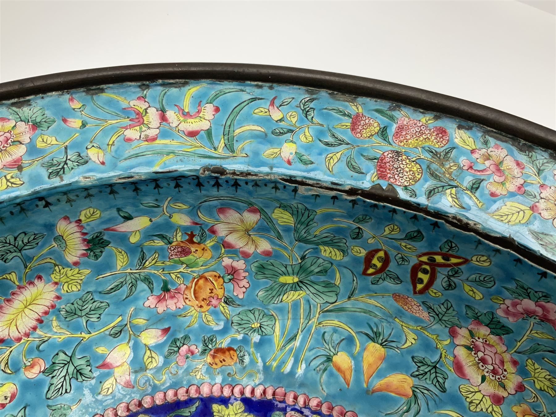 18th/19th century Chinese Canton enamel basin, the circular basin with flat everted rim, decorated with scrolling foliate and fruit decoration on a blue ground, D43cm