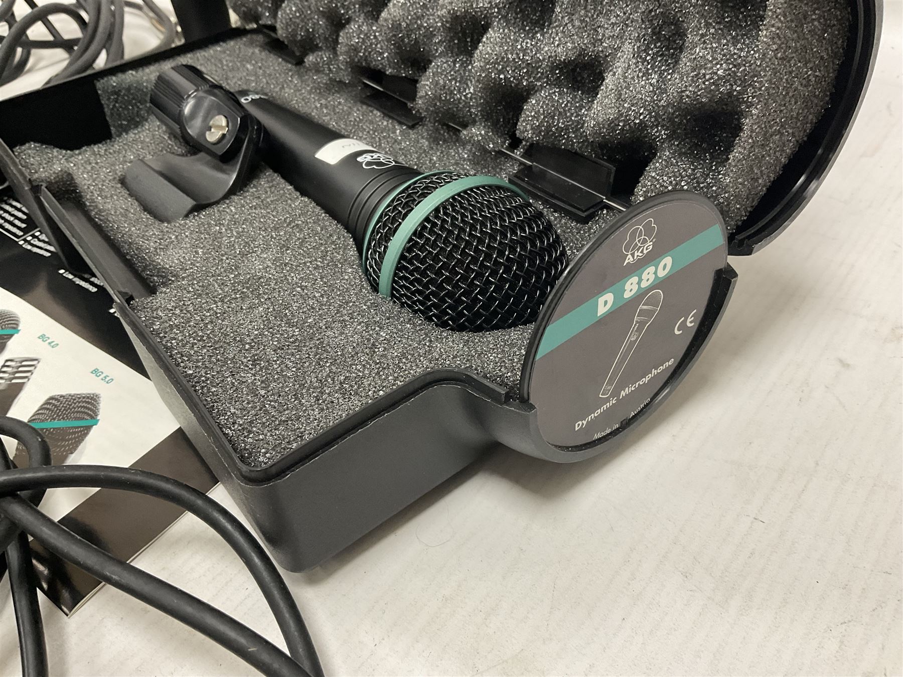 Vintage pair Akai ADM-8 Dynamic microphones; AKG D880 Dynamic microphone; cased; and Shure Betagreen BG1.0 vocal microphone; boxed; all with cables (4)