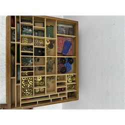 Large collection of Meccano, including perforated strips, wheels, cogs, nuts and bolts, various Meccano instruction manuals and magazines, all housed within a modified wooden box, with three tiered compartmentalised sections and upon four twist legs, box H60cm