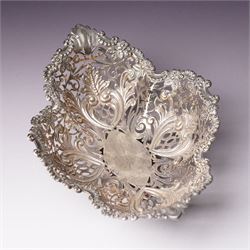 Edwardian silver oval dressing table box, the hinged cover embossed with angel heads W10cm London 1902 Maker William Comyns & Sons and an Edwardisn pierced silver oval sweetmeat basket L18cm Sheffield 1907 Maker James Dixon & Sons Ltd