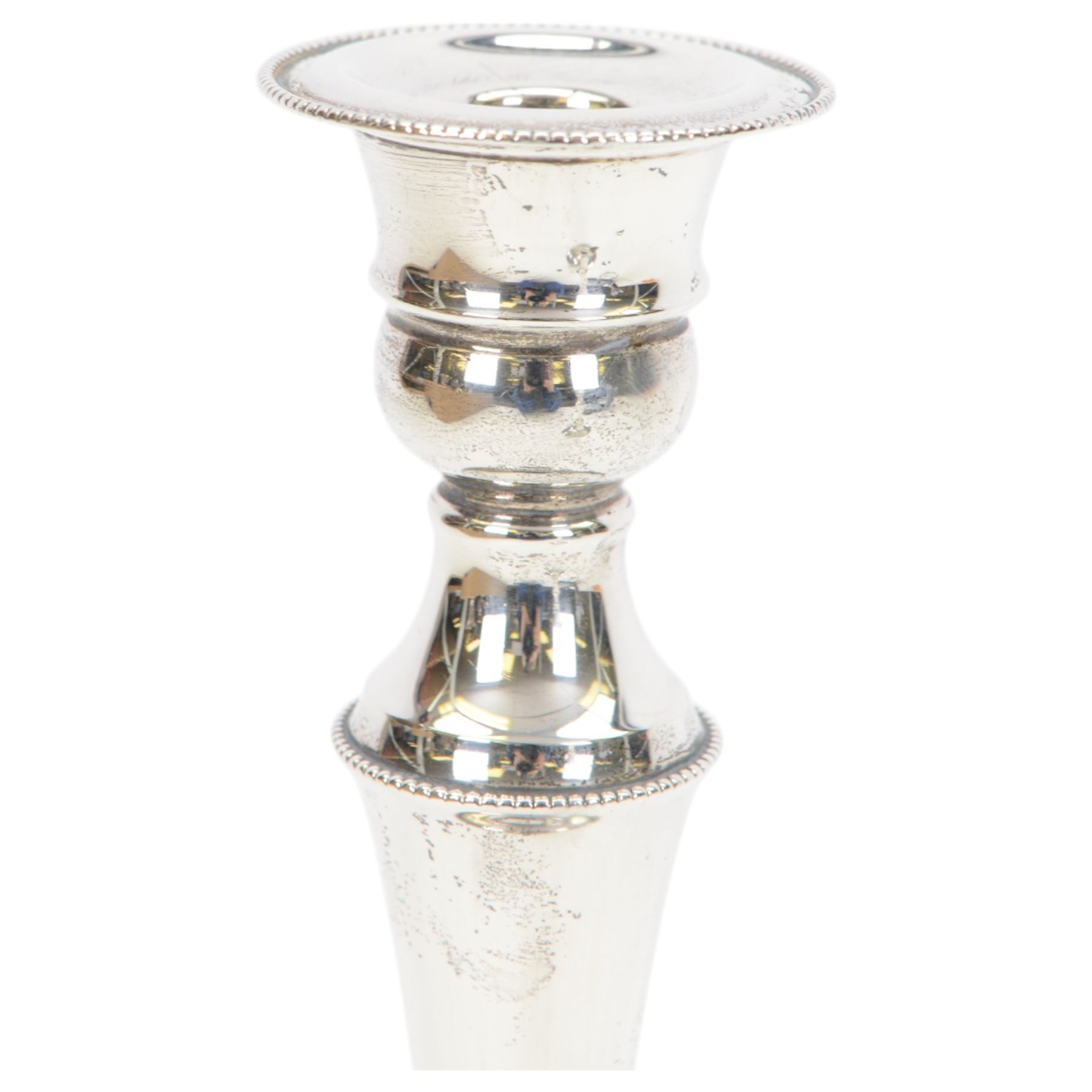 Pair of late 20th century silver mounted candlesticks, of tapering form with beaded rims, hallmarked Cooper Brothers & Sons Ltd, Sheffield 1972, H20cm