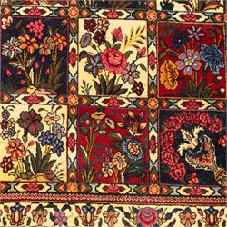 Central Persian Bakhtiar hand-knotted runner, field arranged with a garden panel  design of floral sprays and foliage within a flowerhead and vine border, in tones of crimson, ivory, and indigo with cotton fringe ends 