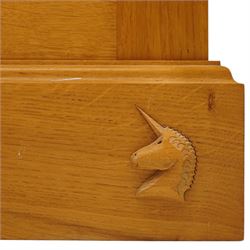 Unicornman - craftsman made oak bedside cupboard, raised back over panelled cupboard, on skirted base applied with carved unicorn signature, by Geoff Gell of Coxwold