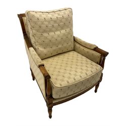 Wesley Barrell - beech framed armchair, upholstered in floral patterned fabric, on turned supports
