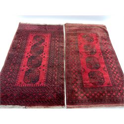 Two similar mid 20th century Afghan Bokhara red ground rugs