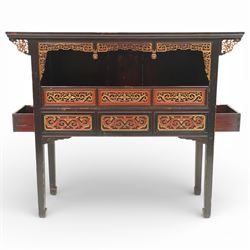 Chinese black lacquer Buddha cabinet, moulded top over open display recess framed by pierced geometric fretwork and corner spandrels, the base fitted with an arrangement of five drawers with carved and gilt scrollwork panels, on square supports with shaped apron brackets