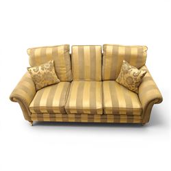 Alstons - 'Ixworth' three seat sofa, upholstered in striped fabric, with loose seat cushions and scrolled arms, front brass castors